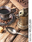 Coffee in the oriental style. Vintage set with a cup of coffee on saucer in oriental style. Стоковое фото, агентство Ingram Publishing / Фотобанк Лори
