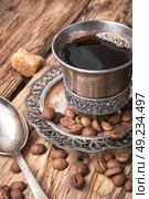 Coffee mug in the oriental style. Vintage cup of coffee on saucer in oriental style. Стоковое фото, агентство Ingram Publishing / Фотобанк Лори