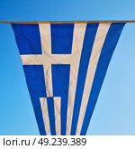 waving greece flag  in the blue sky and      flagpole. Стоковое фото, агентство Ingram Publishing / Фотобанк Лори