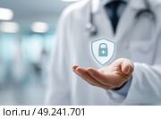 A doctor holding a shield with a cross on it. Стоковое AI-изображение, AI-художник Ярославский Максим / Фотобанк Лори