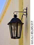 a street lamp  and a yellow wall  in calle de los suspiros in colonia del sacramento  uruguay. Стоковое фото, агентство Ingram Publishing / Фотобанк Лори