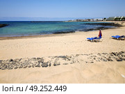 umbrella people footstep coaststone  volcanic spain  water in lanzarote  sky cloud beach  and summer . Стоковое фото, агентство Ingram Publishing / Фотобанк Лори
