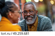 A black man and woman are smiling at each other in a cheerful and heartwarming moment of connection and happiness. Стоковое AI-изображение, AI-художник Данила Большаков / Фотобанк Лори