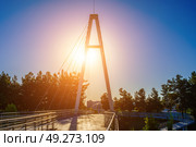 Modern footbridge across the Anhor canal in Navruz park at sunset in summertime, Uzbekistan, Tashkent. (2023 год). Редакционное фото, фотограф Емельянов Евгений Викторович / Фотобанк Лори