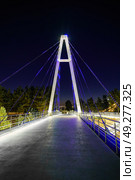Modern footbridge with steel cables across the Anhor canal in Navruz park with illumination lights at night, Uzbekistan, Tashkent. (2023 год). Редакционное фото, фотограф Емельянов Евгений Викторович / Фотобанк Лори
