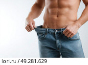 A man is wearing blue jeans and has a very muscular body. Стоковое AI-изображение, AI-художник Ярославский Максим / Фотобанк Лори