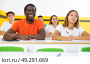 Positive man and woman studying in school for taxi drivers. Стоковое фото, фотограф Яков Филимонов / Фотобанк Лори