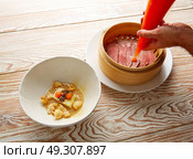 Iberian pork ham with XO sauce and cabbage stew with pork rinds. Стоковое фото, агентство Ingram Publishing / Фотобанк Лори