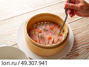 Iberian pork ham with XO sauce recipe chef hand. Стоковое фото, агентство Ingram Publishing / Фотобанк Лори