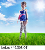 Pretty blond woman walking on the summer meadow. Стоковое фото, агентство Ingram Publishing / Фотобанк Лори