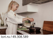 Starting the Morning Right Cracking Eggs Into Frying Pan. Стоковое фото, фотограф Aleksandr Golubev / Фотобанк Лори