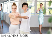 Adolescent dance duo, boy and girl, refining slow foxtrot with female coach. Стоковое фото, фотограф Яков Филимонов / Фотобанк Лори
