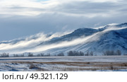 Early morning fog rolling over snowy tundra. Life in permafrost conditions, climate change problems on the planet. Global warming. Стоковое AI-изображение, AI-художник ALLA YURTAYEVA / Фотобанк Лори