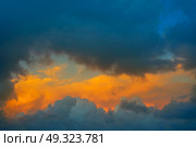 Dramatic clouds at sunset sky orange clouds. Стоковое фото, агентство Ingram Publishing / Фотобанк Лори
