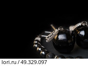 jewel handmade bracelet with semipreciouse stones and earrings with black  semiprecious gem jet at black background. Стоковое фото, агентство Ingram Publishing / Фотобанк Лори