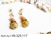 gold handmade earrings with pink semipreciouses. nephritis and variscite. Стоковое фото, агентство Ingram Publishing / Фотобанк Лори