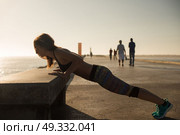 Fitness woman doing exercices on summer sunset. Стоковое фото, агентство Ingram Publishing / Фотобанк Лори