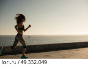 Fitness woman doing exercices on summer sunset. Стоковое фото, агентство Ingram Publishing / Фотобанк Лори