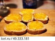 Sandwich with trout red caviar on a board. Close-up. Yellow caviar. Стоковое фото, агентство Ingram Publishing / Фотобанк Лори