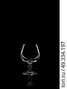 transparent glass for brandy or cognac on black background with reflection. Стоковое фото, агентство Ingram Publishing / Фотобанк Лори