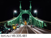 Old Iron Bridge at night in the light of streetlights across the Danube River in Budapest Hungary. Стоковое фото, агентство Ingram Publishing / Фотобанк Лори