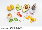 Flat lay of fresh salad vegetables ingredients: avocado, cucumber, paprika, onion, lemon , olives oil and vinegar on white desk background, top view. Healthy lifestyle and vegetarian eating concept. Стоковое фото, агентство Ingram Publishing / Фотобанк Лори