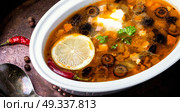 solyanka traditional Russian soup. food of national Ukrainian cuisine.Soup with meat and vegetables. Стоковое фото, агентство Ingram Publishing / Фотобанк Лори