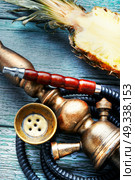 Shisha hookah with pineapple. Stylish hookah with the aroma pineapple for relax.Pineapple shisha.Hooka lounge. Стоковое фото, агентство Ingram Publishing / Фотобанк Лори