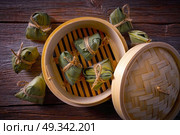 Zongzi Glutinous sticky Rice Dumplings recipe wrap with bamboo leaves asian food. Стоковое фото, агентство Ingram Publishing / Фотобанк Лори