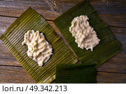 Tamale preparation Mexican recipe with banana leaves and cornmeal. Стоковое фото, агентство Ingram Publishing / Фотобанк Лори