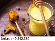 Healthy golden milk. Turmeric Golden milk in a glass cup. Стоковое фото, агентство Ingram Publishing / Фотобанк Лори
