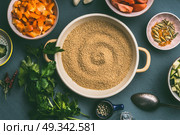 Couscous pot  with cut vegetables ingredients in bowls , top view. Healthy vegetarian food and cooking concept. Стоковое фото, агентство Ingram Publishing / Фотобанк Лори