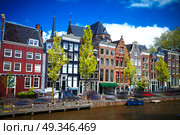 Beautiful view of Amsterdam canals with bridge and typical dutch houses. Holland. Стоковое фото, агентство Ingram Publishing / Фотобанк Лори