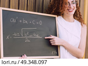Young woman teach with a blackboard . Стоковое фото, агентство Ingram Publishing / Фотобанк Лори