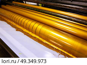 Printer ink machine rotary printing. Printer ink machine rotary printing factory golden printer rollers. Стоковое фото, агентство Ingram Publishing / Фотобанк Лори