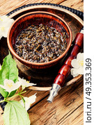 Oriental tobacco hookah with floral jasmine aroma. Smoke hookah with jasmine floral scent.Shisha concept.Modern hookah. Стоковое фото, агентство Ingram Publishing / Фотобанк Лори