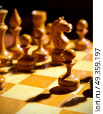 Chessboard with figures on dark background. Стоковое фото, агентство Ingram Publishing / Фотобанк Лори