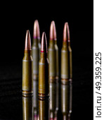 Ammunition cartridges on black background. Ammunition cartridges. Стоковое фото, агентство Ingram Publishing / Фотобанк Лори