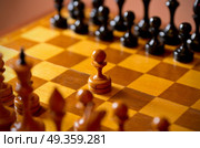Chessboard with figures on dark background. Chessboard with figures. Стоковое фото, агентство Ingram Publishing / Фотобанк Лори