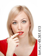 The attractive woman in red has reflected on something, having brought a finger to a mouth, on a white background. Thoughtfulness. Стоковое фото, агентство Ingram Publishing / Фотобанк Лори