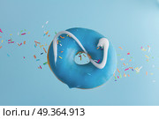 flying doughnuts on blue. one flying sweet doughnut with sprincles on blue. Стоковое фото, агентство Ingram Publishing / Фотобанк Лори