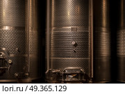 cellar with wine barrels. cellar with modern metal wine barrels rows close up. Стоковое фото, агентство Ingram Publishing / Фотобанк Лори