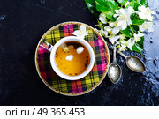 Herbal tea with jasmine. Teacup with tea from jasmine flowers.Green tea. Стоковое фото, агентство Ingram Publishing / Фотобанк Лори
