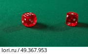 Red gambling dices on green table. Gambling dices on green table. Стоковое фото, агентство Ingram Publishing / Фотобанк Лори