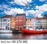 the plane is flying over Nyhavn is the old harbor of Copenhagen. Denmark. Стоковое фото, агентство Ingram Publishing / Фотобанк Лори