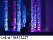 Young kid exploring snoezelen space. Young kid exploring a multi sensory space - snoezelen concept. Стоковое фото, агентство Ingram Publishing / Фотобанк Лори