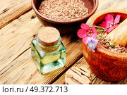 Flax seed,oil and flax flowers in mortar. Heap of linseeds. Стоковое фото, агентство Ingram Publishing / Фотобанк Лори