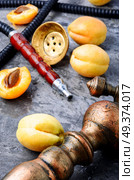 Oriental hookah with the aroma apricot for relax.Apricot shisha. Hookahs shisha with apricot. Стоковое фото, агентство Ingram Publishing / Фотобанк Лори
