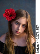 Blond kid girl portrait with hibiscus red flower on hair. Стоковое фото, агентство Ingram Publishing / Фотобанк Лори