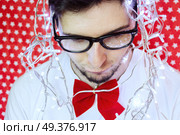 Young funny man celebrating christmas . Стоковое фото, агентство Ingram Publishing / Фотобанк Лори